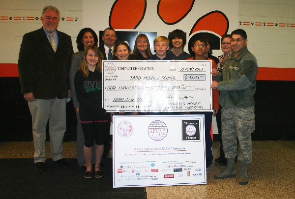 In April, Maj. Aguirre (r) presents a check for $4,025 to students from Tabb Middle School's Science Department along with (back row, l-r) Chris Jacobson, IBM; Terry Guthrie, Tabb Science Department chair; and Mike Morinec, chapter liaison to Tabb.